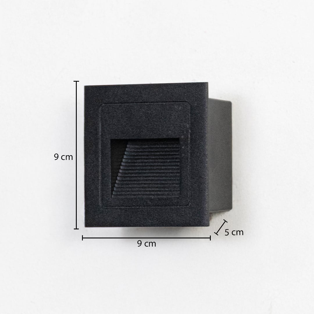 Modern outdoor wall step light in black metal mounted on exterior wall showing 9 cm height 9 cm width and 5 cm depth details.